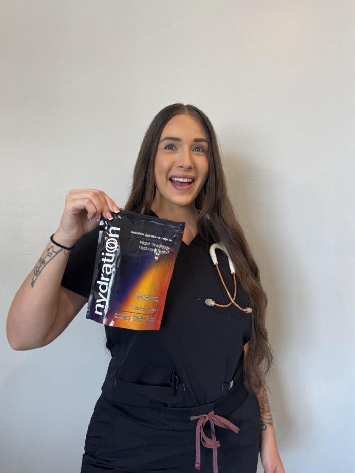 Person holding a 'nydration' package against a plain background